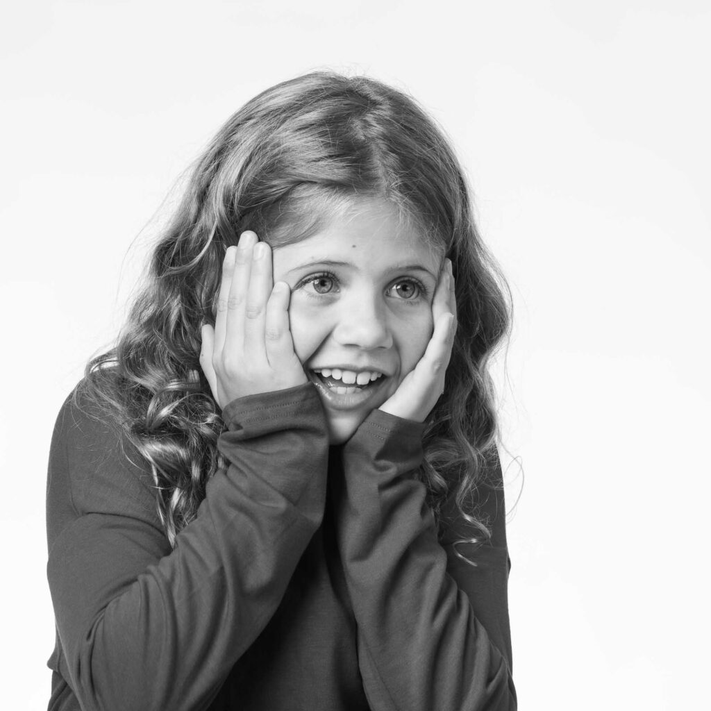 Girl giving a surprised expression during studio portrait session