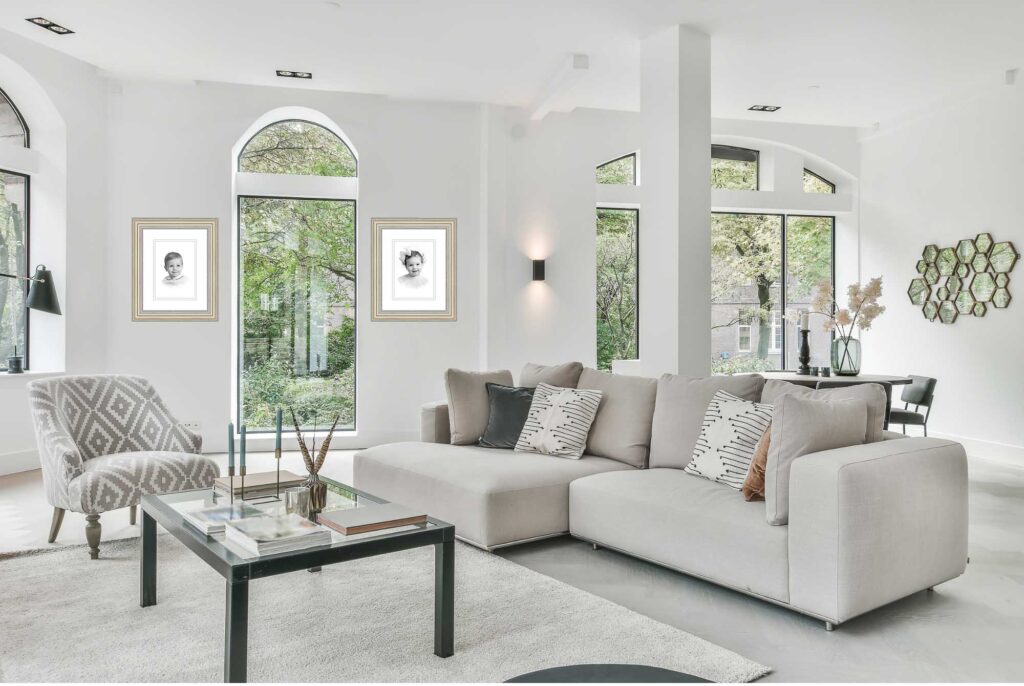 Bright, modern living room featuring a cream sectional sofa styled with neutral pillows, exemplifying the polished home environments where families display their professional portrait photography