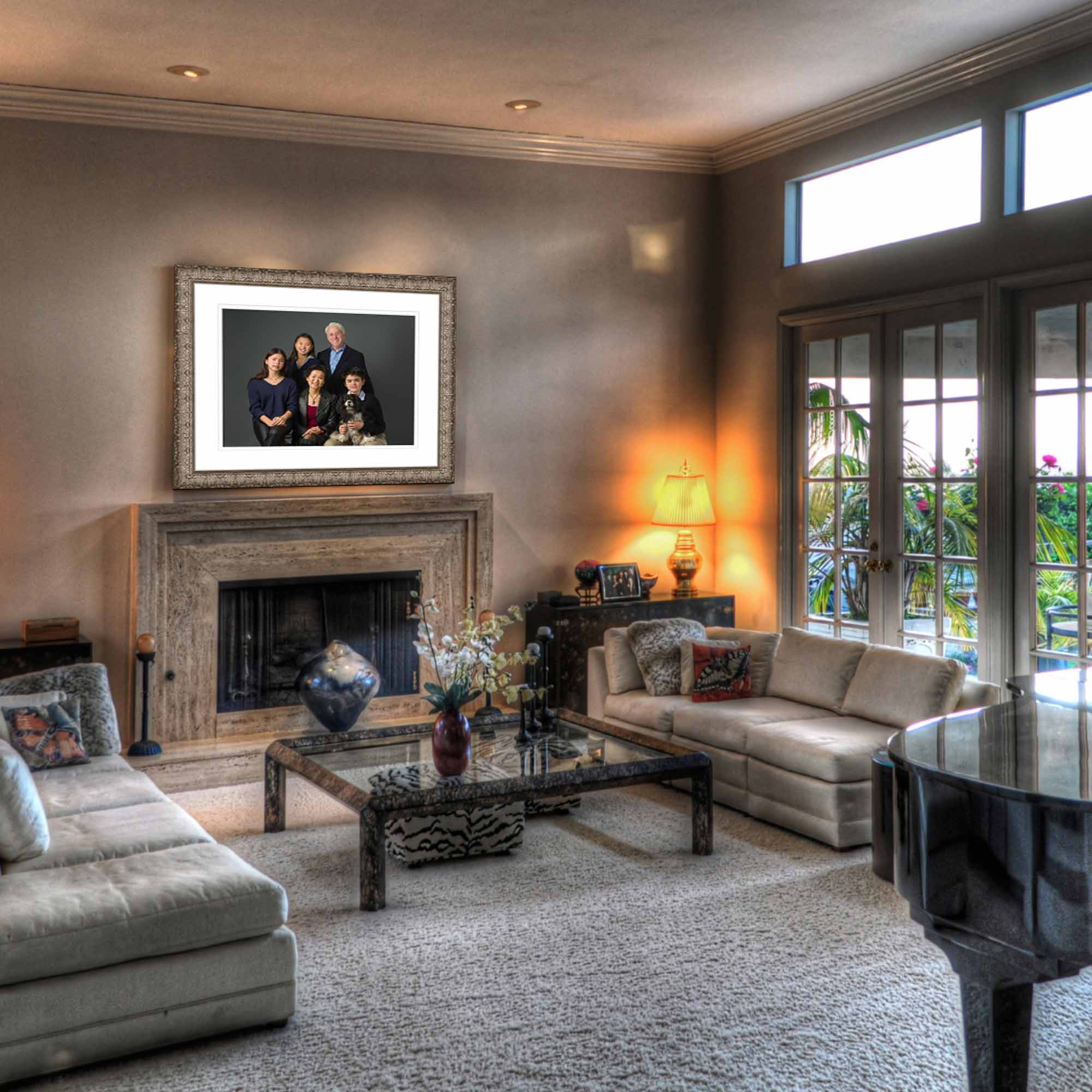 Elegant living room displaying a framed family portrait above a fireplace, showcasing how professional photography transforms into meaningful wall art for your home