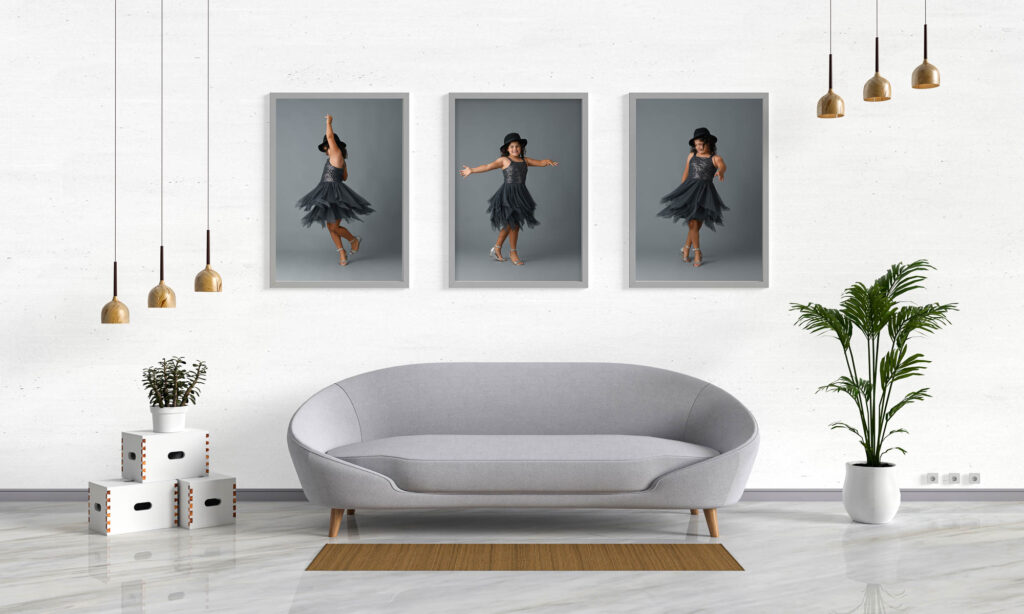 Modern living room display showing three framed portraits of a young girl dancing in a black dress, illustrating how family photography sessions transform into finished wall art for your home