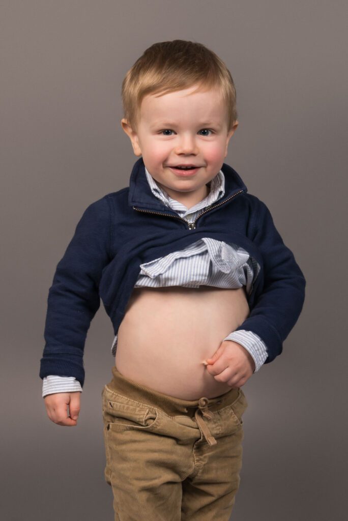 silly toddler with a bare belly