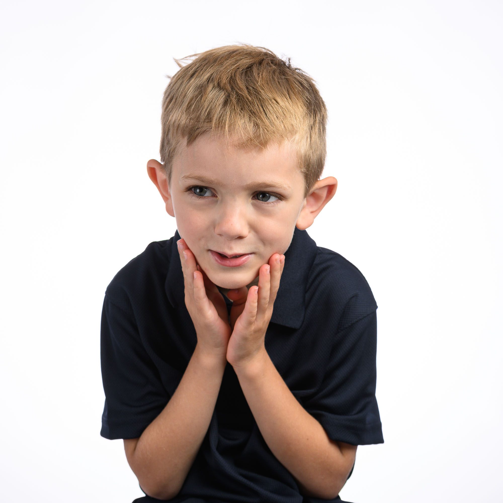 6 year old boy sure he knows the answer to photographer's question