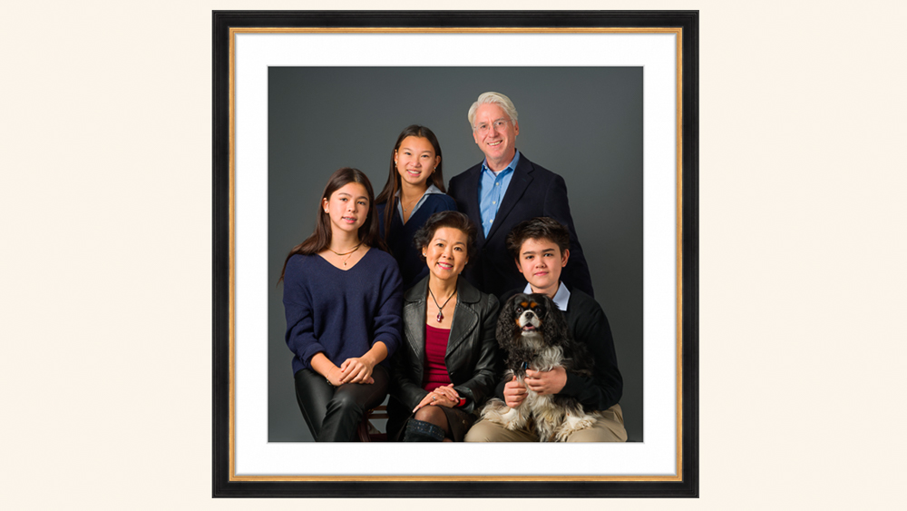 Five-person family posed together with a dog in a framed studio portrait against a gray background | Lisa Maco Photography