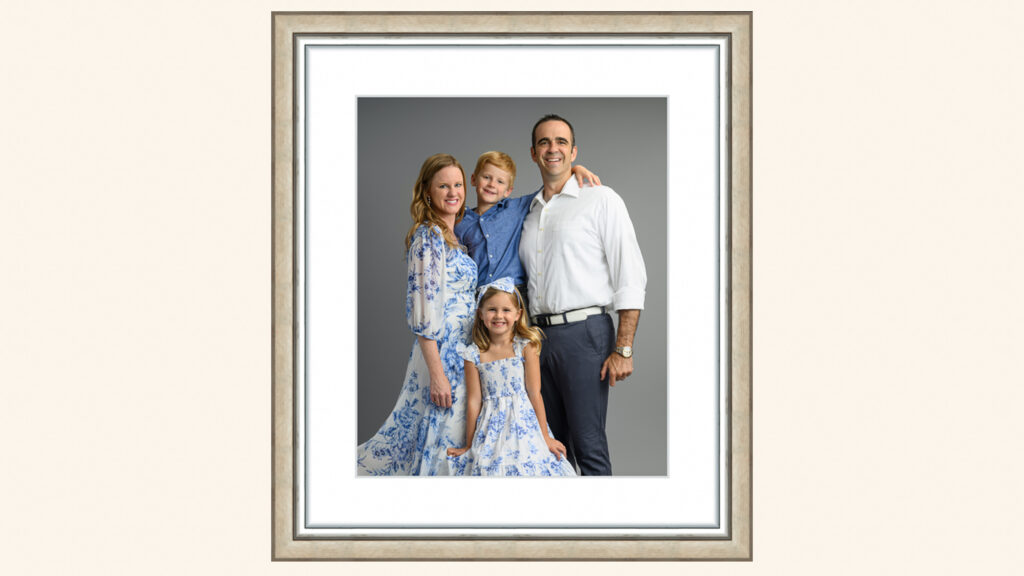 Framed family portrait featuring a mother, father, and two children posing together in a DC studio photography session