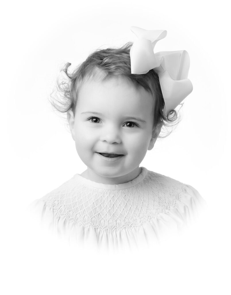 sweet little girl smiles for Heirloom portrait