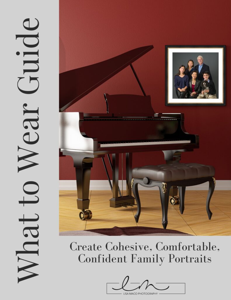 Grand piano with bench against red wall next to framed family portrait photo guide cover
