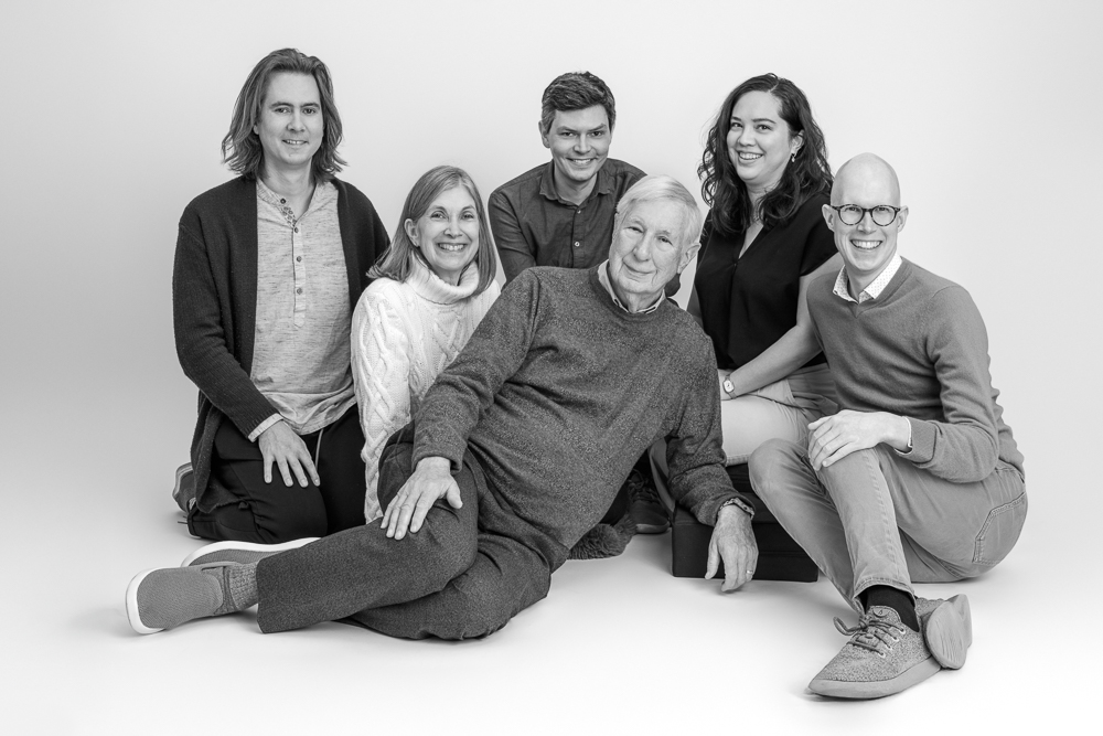 Multi-generational family poses together for a classic black and white studio portrait with DC photographer Lisa Maco