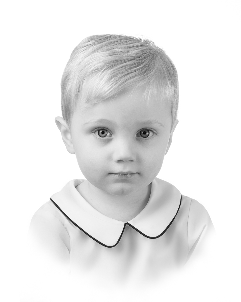 Young boy in a white collared shirt during a classic studio portrait session with DC family photographer Lisa Maco